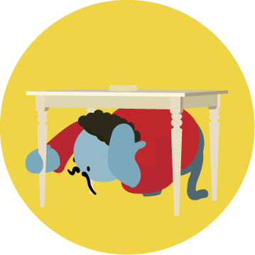 A person doing Drop Cover and Hold under a table